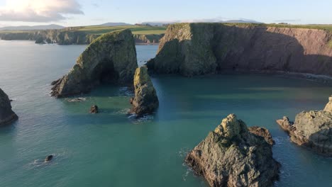 Drone-fly-over-sea-Stacks-sea-caves-and-hidden-beach-Copper-Coast-Waterford-Ireland-natures-beauty