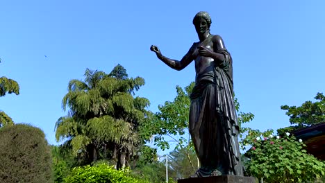 Camera-pan-in-a-garden-next-to-a-gazebo-of-a-greek-goddess-statue-in-Sayaji-Baugh-in-Vadodara-city,-India
