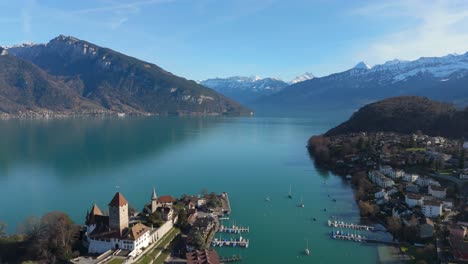Spiez-on-Lake-Thun-with-marina-and-Alps-in-background,-clear-skies,-vibrant-landscape