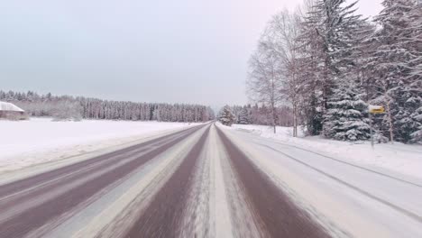 Schnelles-Pendeln-Im-Winter-Auf-Vereister-Straße,-POV-Fahrt-Auf-Der-Ländlichen-Waldautobahn-Finnlands