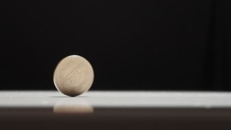 Japanese-10-Yen-Coin-Spinning-on-Table