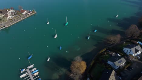 Spiez-on-Lake-Thun-in-Switzerland,-calm-waters-with-boats,-aerial-view