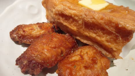 Cinematic-profile-view-of-golden-toasted-French-Toast-Wings-kept-on-a-white-colored-dish