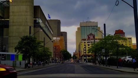 Montreal-Chinatown-Convention-Center-storm-front-coming-in-as-pedestrian-flood-side-walk-prior-to-rush-hour-with-iconic-skyline-of-classic-early-1900s-architecture-in-the-background-in-post-modern-era