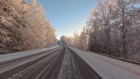 Dazzling-winter-sunlight-blinds-drivers-POV-commute-on-rural-roads-Finland