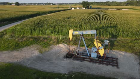 Pumpjack-pumping-oil-in-countryside-of-Michigan,-aerial-view