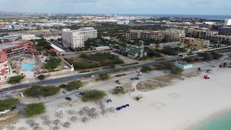 -Eagle-Beach-aerial-drone-shot,-hotel-resorts-in-aruba