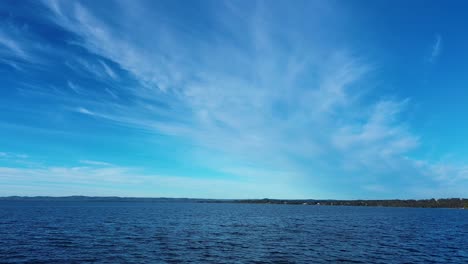 Drone-aerial-Tuggerah-lakes-water-river-inlet-with-blue-sky-bushland-coastline-Toukley-Gorokan-Noraville-Central-Coast-travel-tourism-Australia