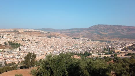 Panoramic-view-of-Fes-and-surrounding-mountain-range-from-distance-in-daylight-from-Morocco