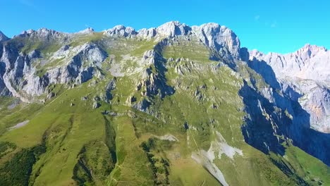 Droning-over-Picos-de-Europa:-Towering-peaks-embrace-the-sky,-a-rugged-mosaic-of-nature's-splendor