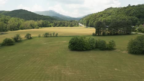 Drone-Shot-of-Field-Revealing-Appalachian-Mountain-Valley