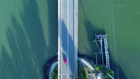 Drone-aerial-of-freeway-highway-bridge-crossing-lake-water-with-wharf-Central-Coast-Toukley-Budgewoi-Central-Coast-Australia