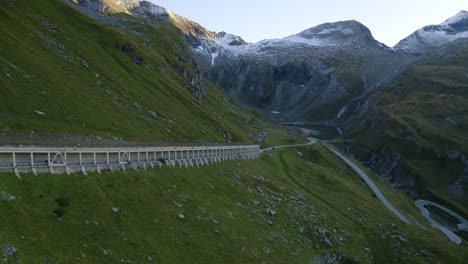 A-cinematic-aerial-shot-of-a-car-driving-in-an-open-tunnel-on-a-mountain-highway