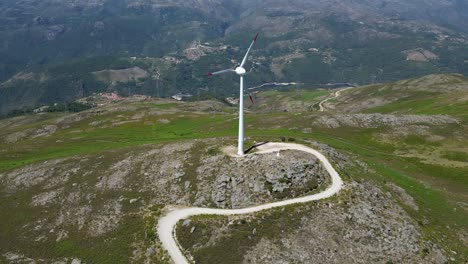 wind-turbine-rotating-on-top-of-a-mountain-overlooking-Gerês,-renewable-wind-energy-portugal