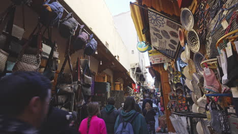 people-walking-inside-little-narrowed-street-of-the-market