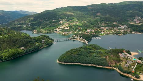 Aerial-View-of-Caldo-River's-Bridge-over-Caniçada,-Gerês,-Northern-Portugal-with-Stunning-Lake-Reflections
