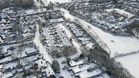 Aerial-of-beautiful-snow-white-suburban-neighborhood-on-a-winter-day
