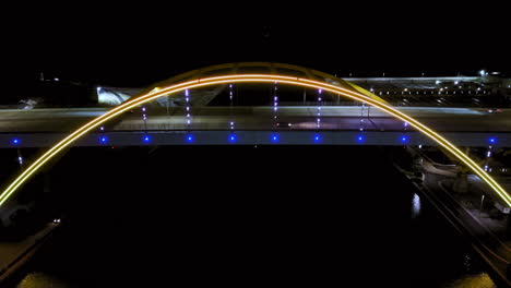 Aerial-view-tilting-in-front-of-the-Hoan-Bridge,-nighttime-in-Milwaukee,-USA
