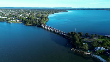 Drone-aerial-cars-driving-over-Toukley-bridge-on-Tuggerah-Lake-Gorokan-boat-ramp-travel-tourism-coastline-suburbs-Central-Coast-Australia