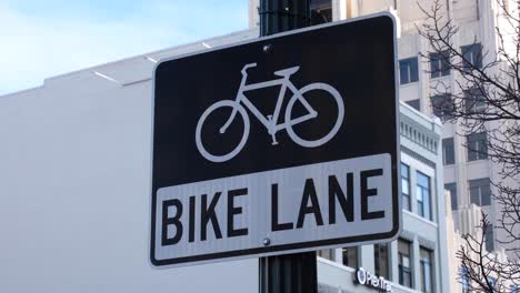 Close-up-sign-with-bicycle-graphic-for-bike-lane-on-the-streets-in-downtown-Boise-city-in-Idaho,-USA