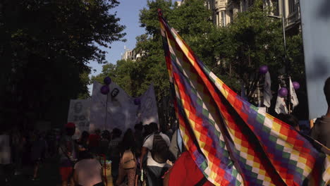 political-colourful-flag-waves-at-public-street-gathering,-representing-human-rights-issues-for-native-people