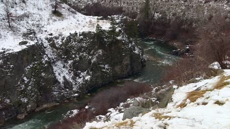 River-Meandering-Through-Canyon-And-Forest-During-Winter