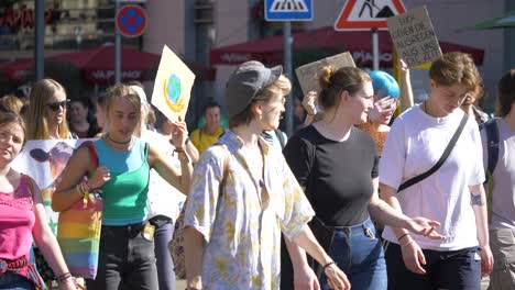Fridays-for-Future-FFF-protest-by-young-and-elderly-activists-walking-and-marching-together-against-climate-change-and-for-green-energy-and-sustainability-in-Stuttgart,-Germany
