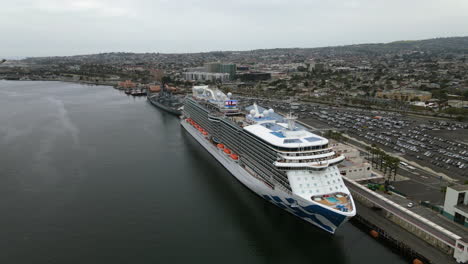 Aerial-view-rising-over-a-large-cruise-liner-docked-in-cloudy-Los-Angeles,-USA