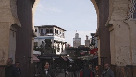 group-of-tourist-entering-the-blue-door-gate-of-the-old-town-welcoming-new-visitors-in-the-famous-center-of-the-city