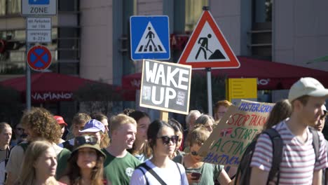 Fridays-for-Future-FFF-protest-with-young-and-elderly-activists-marching-together-against-climate-change-and-for-green-energy-and-sustainability-in-Stuttgart,-Germany