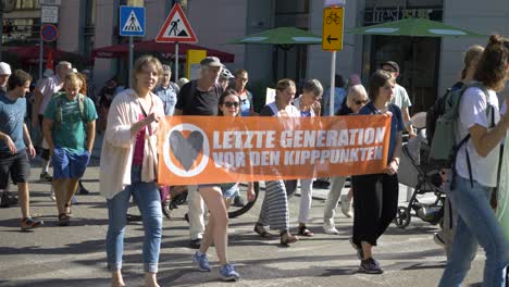 Fridays-for-Future-FFF-protest-with-youth-and-elderly-marching-together-on-the-streets-against-climate-change-and-for-green-energy-and-sustainability-in-Stuttgart,-Germany