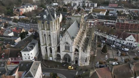 Old-French-Gothic-Cathedral-in-Small-Town,-Normandy-France,-Aerial-Drone