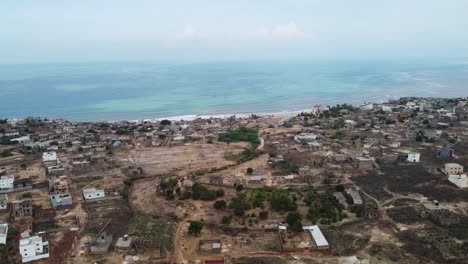Ariel-view-of-small-coastal-Senegalese-town,-near-Toubab-Dialaw