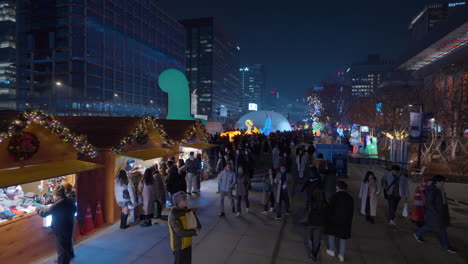 Crowd-of-Tourists-on-Gwanghwamun-Square-at-Night-Shopping-Christmas-Gifts-in-Outdoor-Christmas-Market-Stalls-2023---high-angle-view