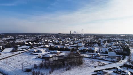 Aerial-view,-city-in-the-distance,-winter-landscape-from-a-drone