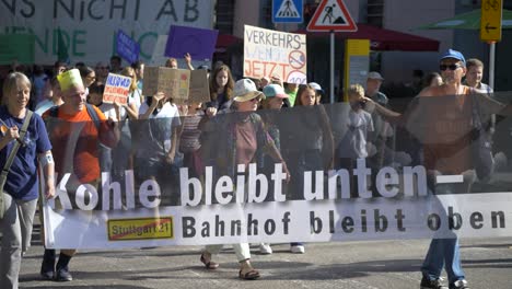 Fridays-for-Future-FFF-protest-by-young-and-elderly-activists-walking-together-against-climate-change-and-for-green-energy-and-sustainability-in-Stuttgart,-Germany