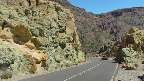 Country-road-leading-through-volcanic-mountain-landscape-in-Tenerife
