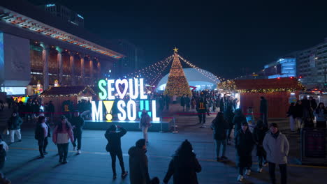 Seoul-My-Soul-Monument-in-the-Entrance-of-Christmas-Market-on-Gwanghwamun-Square-at-Night-2023,-Crowd-of-People-Sightseeing-on-Year-Year-Eve-in-City-Downtown
