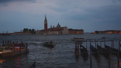 Canal-with-gondolas-during-the-night-in-San-Marco,-views-of-San-Giorgio-Maggiore