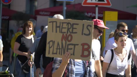 Fridays-for-Future-FFF-protest-with-activist-marching-and-holding-sign-saying-there-is-no-planet-B-in-Stuttgart,-Germany