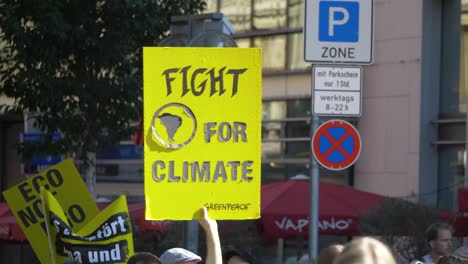 Fridays-for-Future-FFF-protest-with-activists-marching-and-holding-sign-saying-fight-for-climate-in-Stuttgart,-Germany