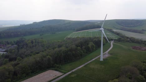 Drone-shot-of-a-wind-turbine-in-the-South-Downs,-England
