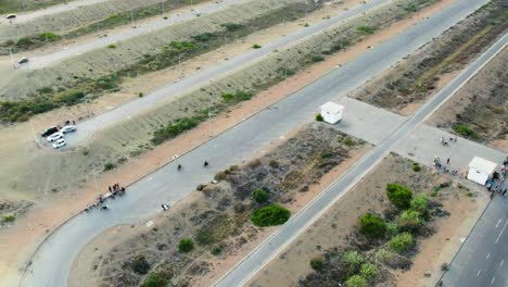 Aerial-view-of-a-sparse-desert-road-with-scattered-vegetation