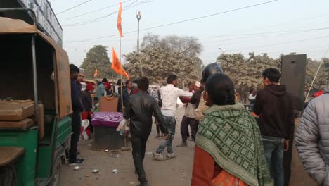 Festive-Indian-Hindu-men-dancing,-celebrating-consecration-of-ram-mandir-in-Ayodhya-chanting-jai-Shree-ram-together-in-joy