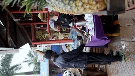 People-Having-Breakfast-at-a-Market-in-Tanzania,-East-Africa---Vertical-Shot