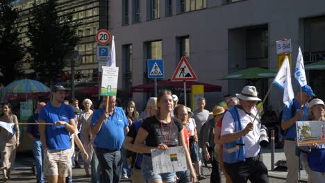 Fridays-for-Future-FFF-protest-with-young-and-elderly-marching-together-on-the-streets-against-climate-change-and-for-green-energy-and-sustainability-in-Stuttgart,-Germany
