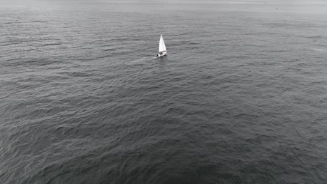 Aerial-Shot-Of-White-Boat-Sailing-In-Heart-Of-Ocean,-Puente-Alto,-Chile