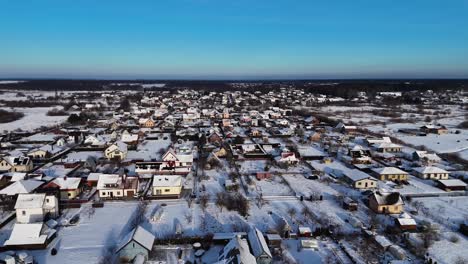 Amazing-winter-landscape-in-village-residential-streets,-left-aerial-view,-snow-day
