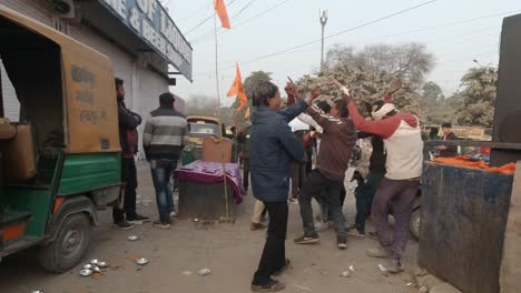 Festive-Indian-Hindu-men-dancing,-celebrating-consecration-of-ram-mandir-in-Ayodhya-chanting-jai-Shree-ram-together-in-joy
