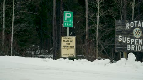 A-Group-of-Entry-Signs-for-No-Licensed-Trapping-Permitted-Rotary-Suspension-Bridge-Pisew-Falls-Travel-Manitoba-Winter-Forest-Provincial-Park-near-Artic-Northern-Thompson-Canada